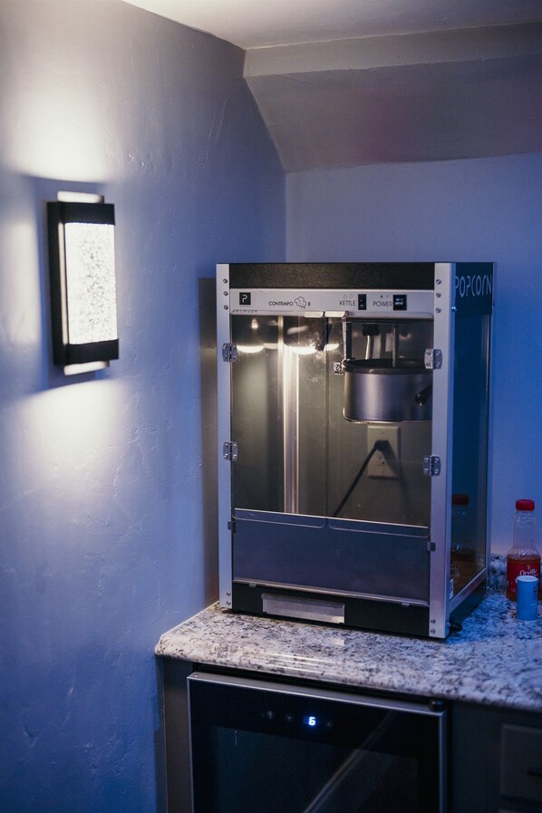 Een popcornmachine in een keuken, met een aanrecht en een vaatwasser.