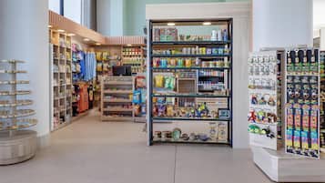 A store with shelves stocked with various items, including snacks, toys, and decorative objects.