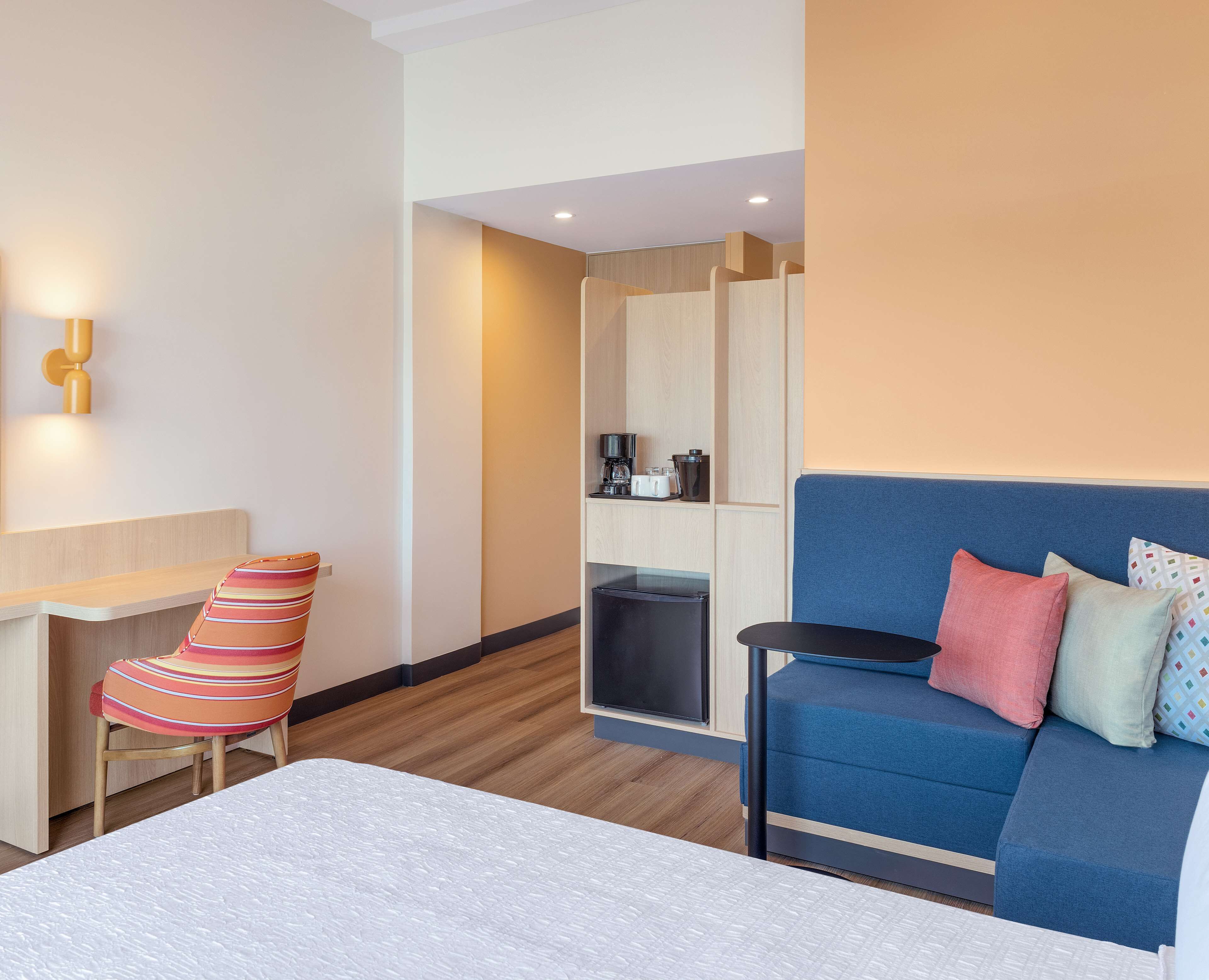 queen room w/ sofa bed and fridge | living area | 50-inch tv with cable channels