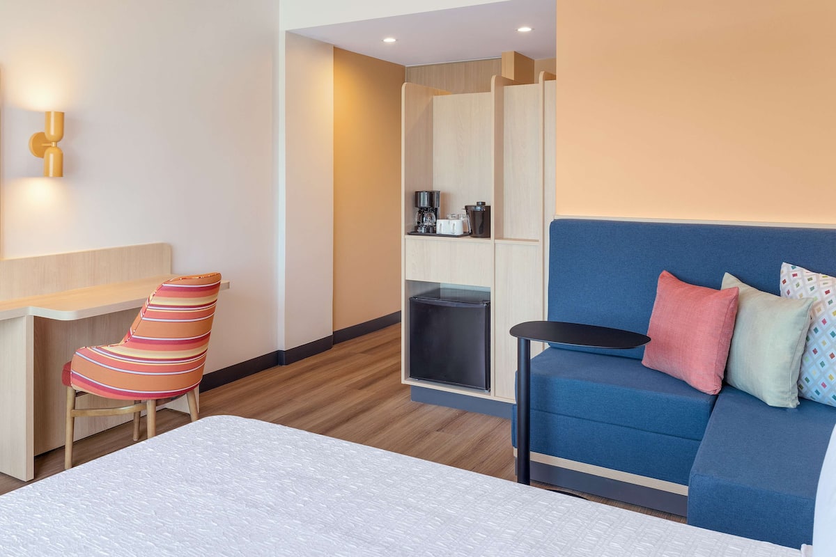 queen room w/ sofa bed and fridge | living area | 50-inch tv with cable channels