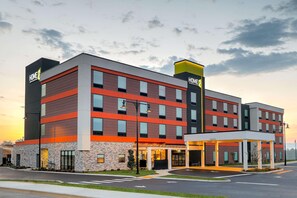 A multi-story hotel with a modern design, featuring a prominent "HOME2" sign, a covered entrance, and a landscaped front area. - Home2 Suites By Hilton Alcoa Knoxville Airport (Alcoa)