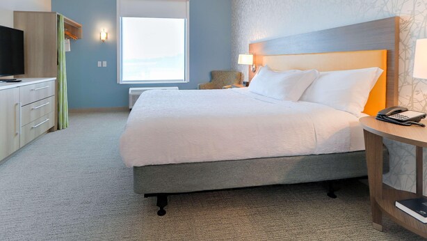 A hotel room with a bed, a desk, a chair, and a television. - Home2 Suites By Hilton Alcoa Knoxville Airport (Alcoa)