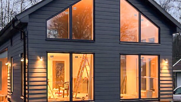 A modern two-story house with large windows and a garage door. - 1 bedroom awesome home in Hörby (Hörby)