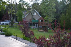 Enjoy a serene residential setting with a beautifully maintained lawn and a charming playhouse.