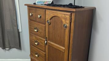 A wooden dresser with drawers and a globe on top.