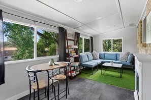 Relax in a peaceful setting with a view of the surrounding greenery from the large window.