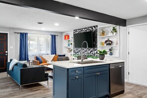 Enjoy a city view from the large window in this apartment's kitchen, which features a central island and dishwasher.