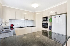 Enjoy cooking and tea preparation in this well-equipped kitchen with a double sink and modern appliances.