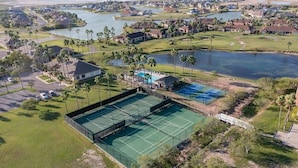 An aerial view of a residential area with a tennis court, a pool, and a golf course. - Single Family Home - 52 BP (Laguna Vista)