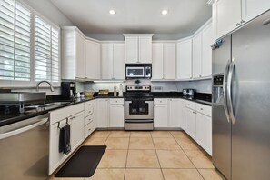 Fridge, coffee/tea maker, cookware/dishes/utensils, spices
