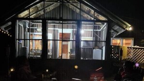 A cozy room with a fireplace, a large window, and a view of the interior. - Relaxing rustic cabin on the lake 25 feet from the shore. (Baileyville)