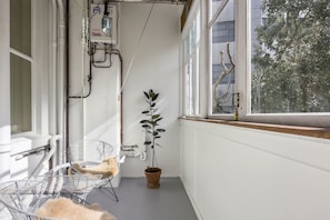 Enjoy a peaceful retreat with a window view of a tree and a potted plant nearby.