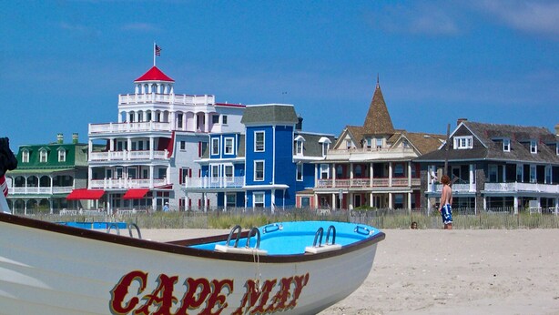 A beach with a boat named "Cape Main" and colorful buildings in the background. - Stylish 1BR Apartment in Cape May (Cape May)