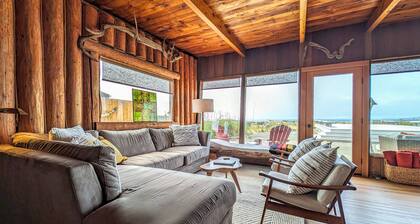Charming water view retreat with a wood-burning fireplace, deck, grill, and W/D