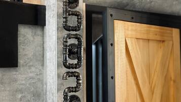 A concrete wall with a metal pipe structure and a wooden door.