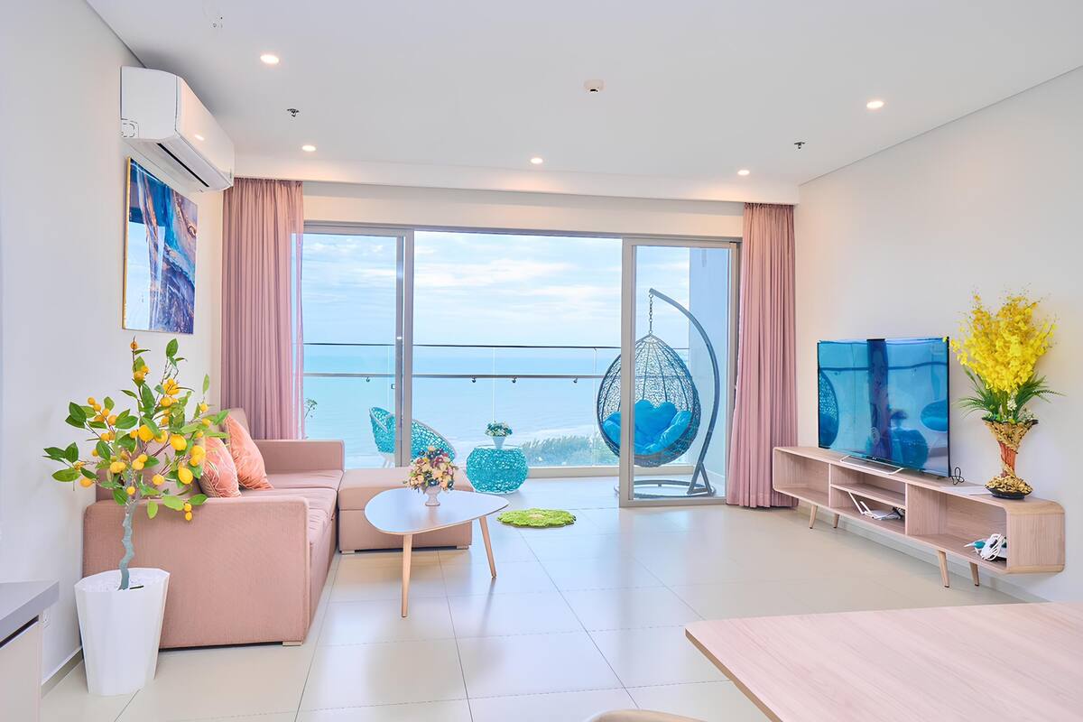 A modern living room with a sofa, coffee table, and TV stand.