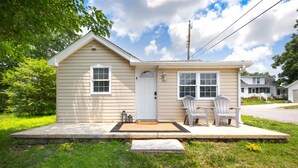A small, single-story house with a front porch, two windows, and a door. - Charming, Private Abode: Serenity in Hopewell, VA! (Hopewell)