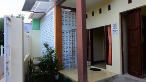 A building with a gated entrance, a sign for 'A-ESYS Home', and a door marked with the number 23. - Alesya Homestay Syariah (Yogyakarta)
