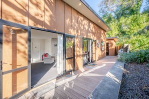 Enter a serene oasis with a wooden deck and lush surroundings.