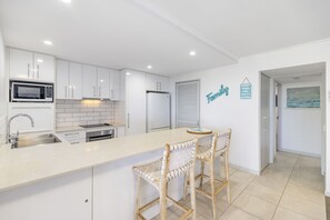 Enjoy cooking in this well-equipped kitchen with a central island and appliances.