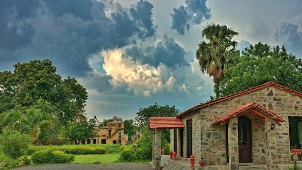 A stone building with a red-tiled roof, a small porch, and a door with a sign. - Barabagh Deogarh (Devgarh)