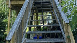 A wooden staircase leading to a deck with a fish-shaped decoration. - Cute Loft , Ideal Location to Bayside Camden and Belfast
Day trip to Bar Harbor! (Northport)