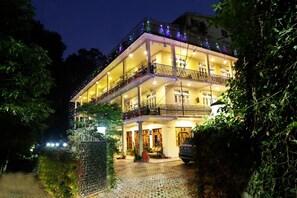 A multi-story hotel with balconies, a paved entrance, and a gated driveway. - Hotel Aroma Nainital (Nainital)