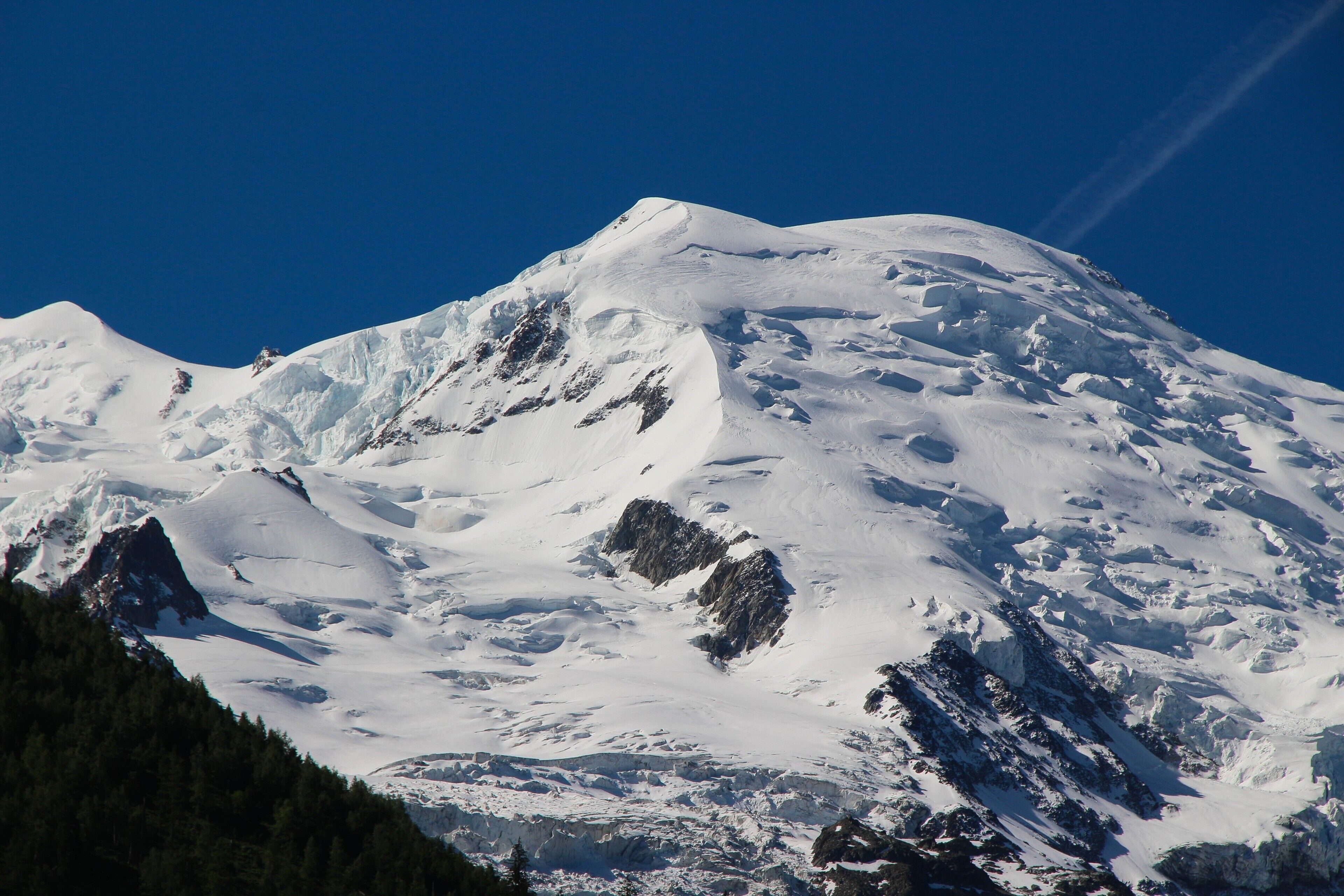 A snow-covered mountain with a clear sky.