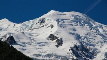 A snow-covered mountain with a clear sky.