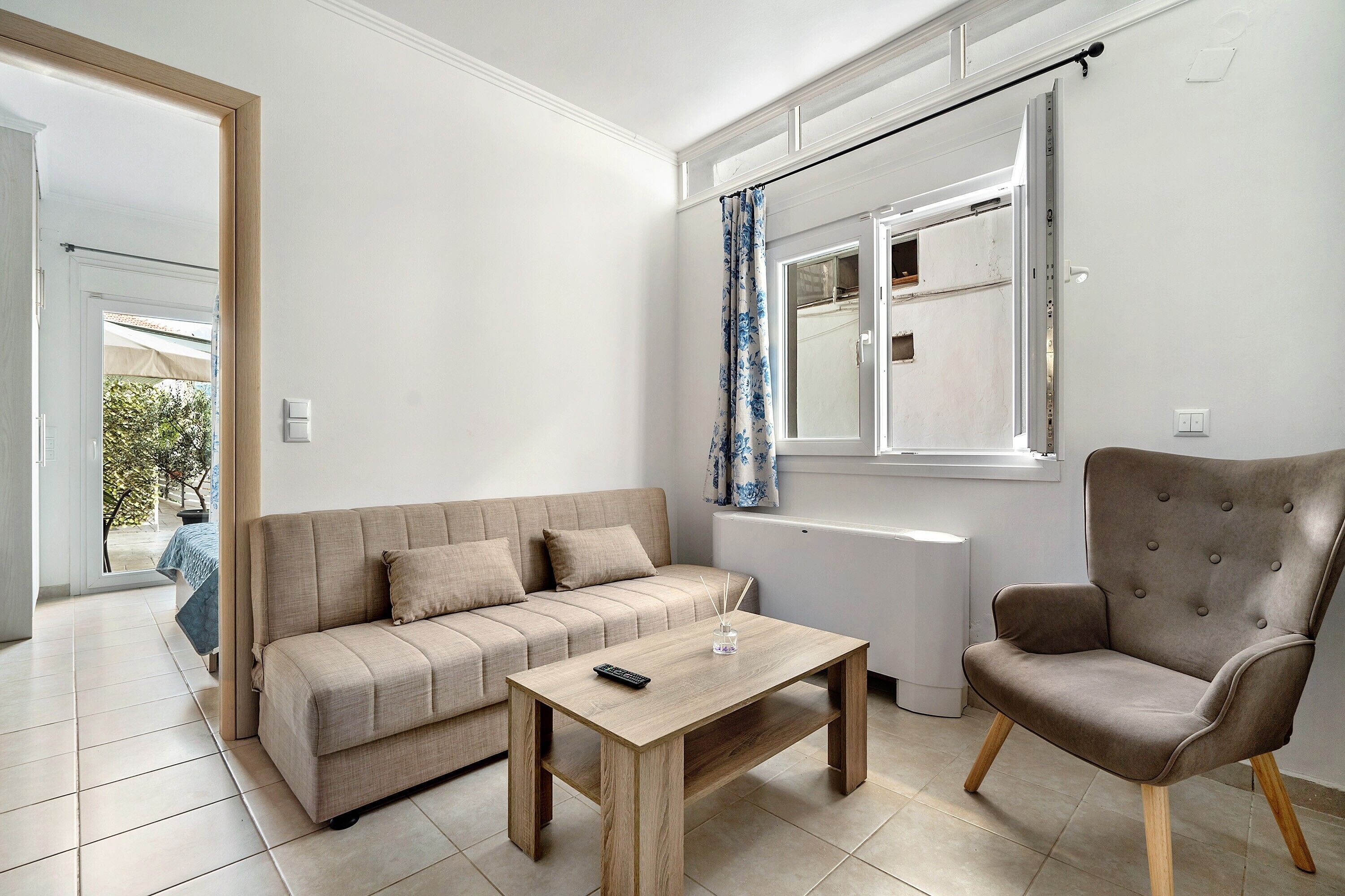 A living room with a sofa, a coffee table, and a chair.