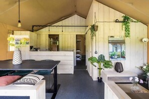 Enjoy a warm and inviting space with a dining area, potted plants, and a window offering a view of the outdoors.