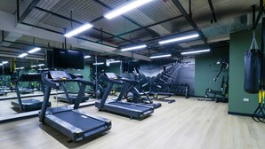 A gym with treadmills, exercise equipment, and a large mirror. - w* | Spectacular 2BR in the Heart of Miraflores (Miraflores)