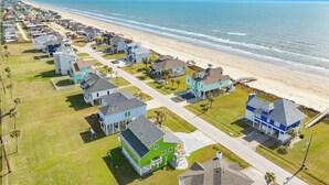A coastal residential area with houses along the beach, featuring a mix of single and two-story buildings, some with visible balconies and driveways. - Epic 6BR Beach View * Steps to Beach * Sleeps 20+ (Galveston)