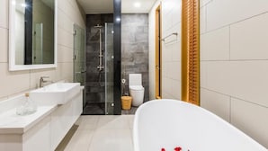 A modern bathroom with a bathtub, a shower, and a toilet. - SAKI VILI HO TRAM (Ho Chi Minh City)