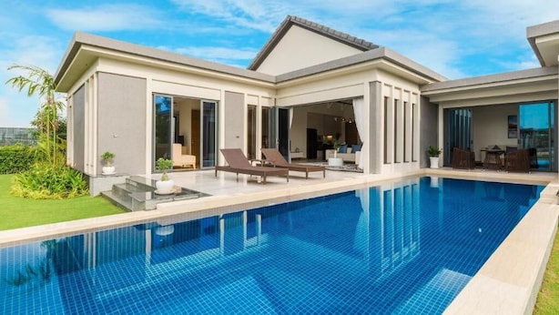 A modern house with a swimming pool, large windows, and a well-maintained lawn. - SAKI VILI HO TRAM (Ho Chi Minh City)
