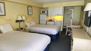 A hotel room with two beds, a desk, a chair, a microwave, a refrigerator, and a small kitchenette. - Oceanfront Efficiency T401 (Myrtle Beach)