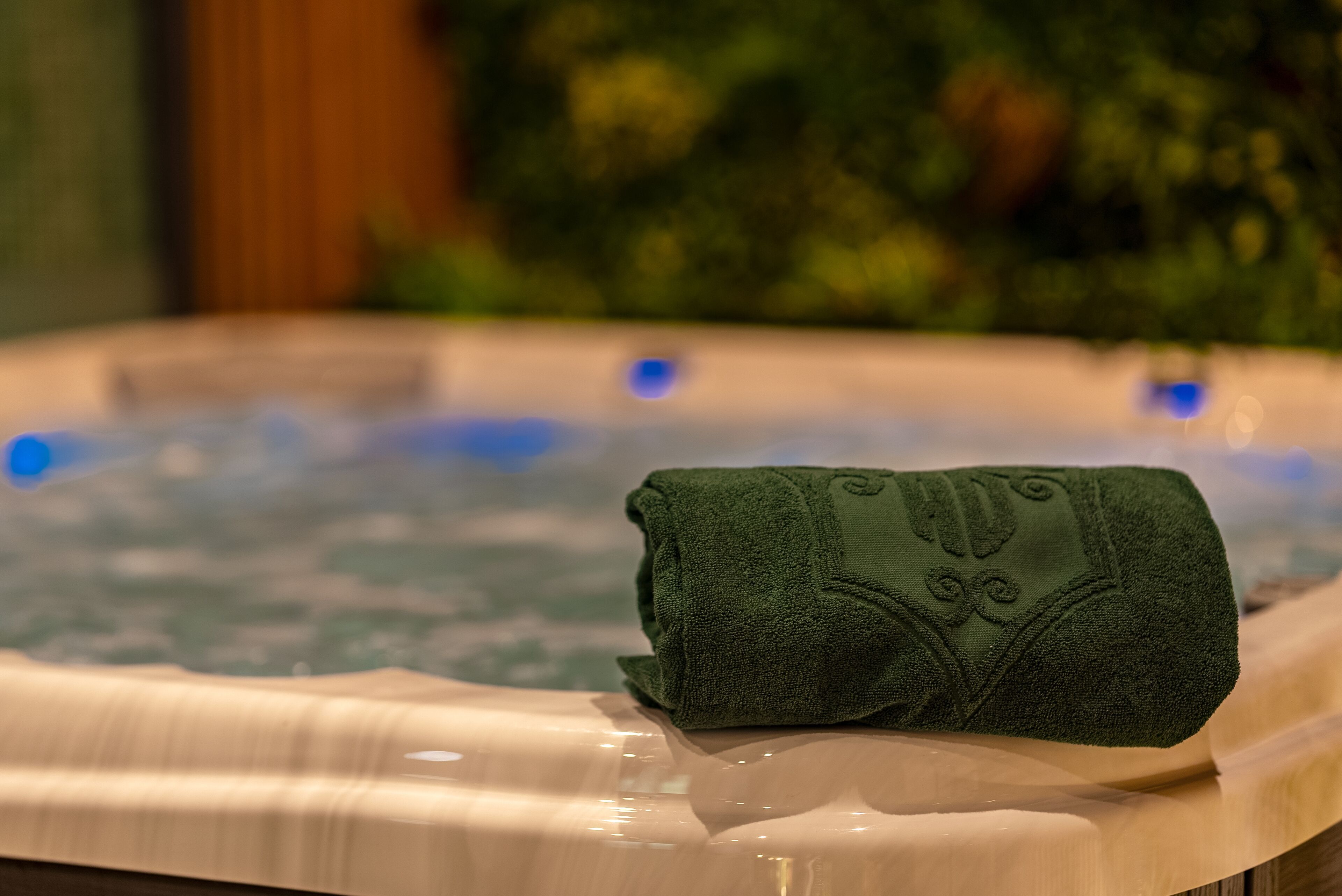 A hot tub with a green towel on the edge.
