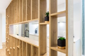 A modern interior with wooden shelving units and potted plants. - Amplio y Moderno Apartamento en la Maestranza (Sevilla)