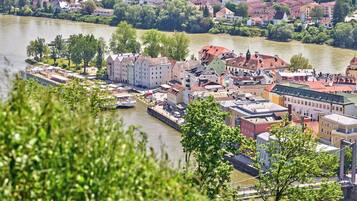 A riverside town with historic buildings, a bridge, and a boat dock.