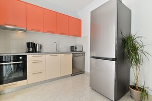 Enjoy cooking in this well-equipped kitchen with a refrigerator, oven, and dishwasher.