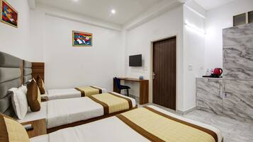 A hotel room with two beds, a desk, a TV, a wardrobe, and a marble wall.