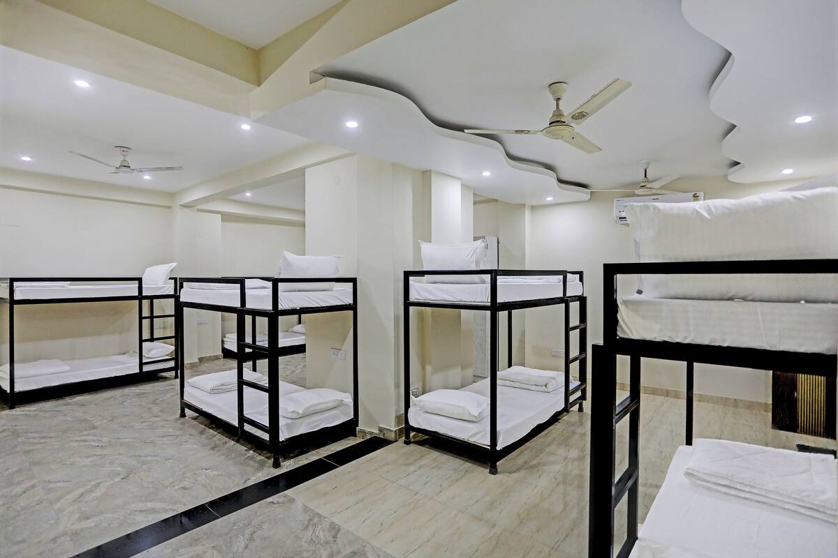 A hotel room with bunk beds, ceiling fans, and recessed lighting.