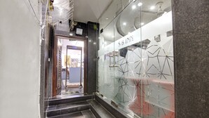 A hotel entrance with a glass wall displaying geometric patterns and the name 'SB INNY'. - Hotel S B Inn Paharganj (New Delhi)