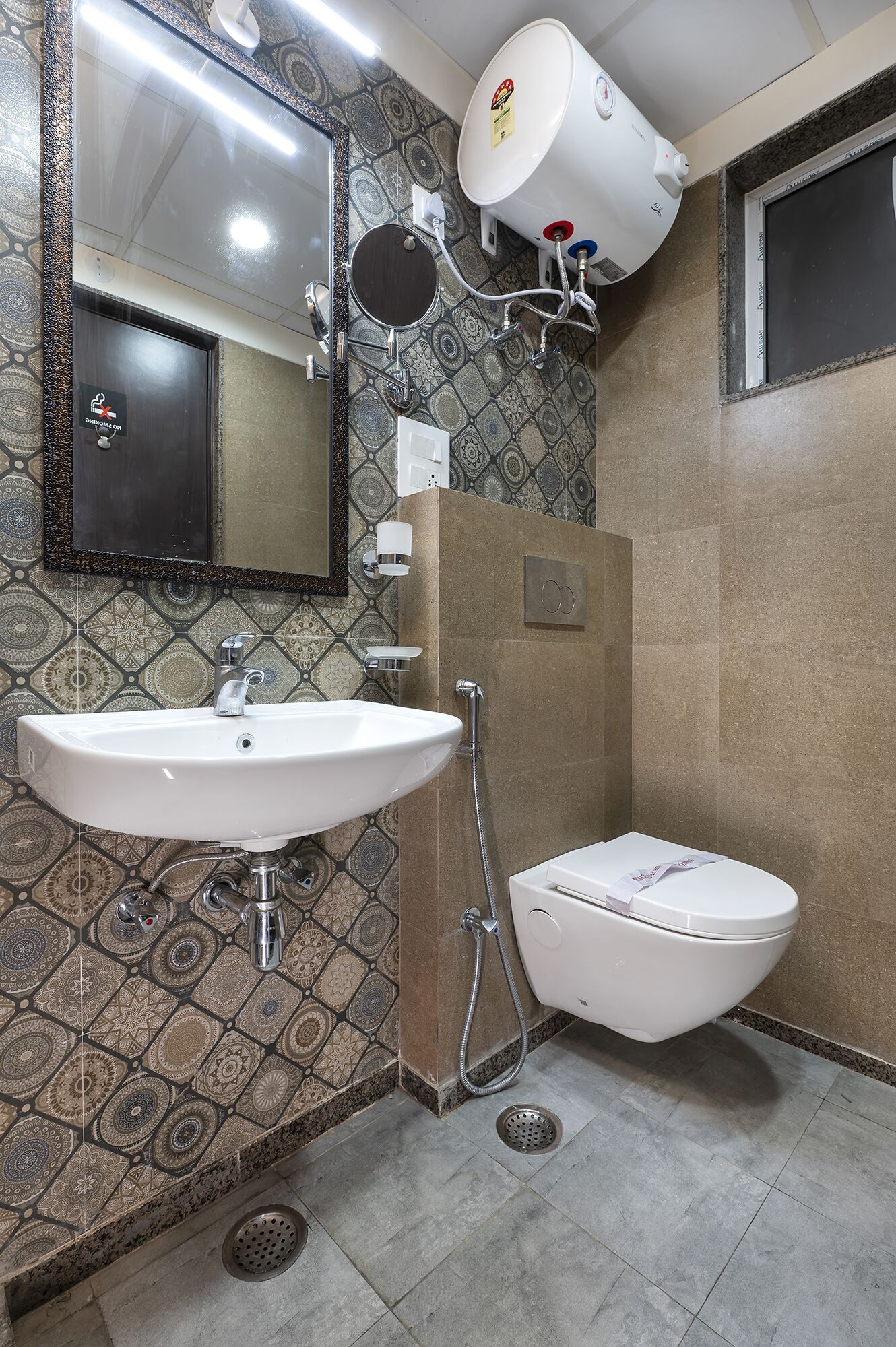 A bathroom with a sink, toilet, and a towel warmer.