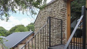 A staircase leading up to a stone building with metal railings. - The Coach House at Thorn Farm (Exeter)