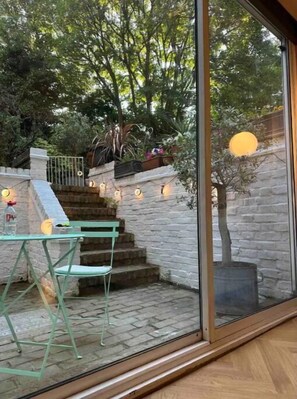 Enjoy a peaceful retreat with a stone wall, wooden staircase, and seating area.