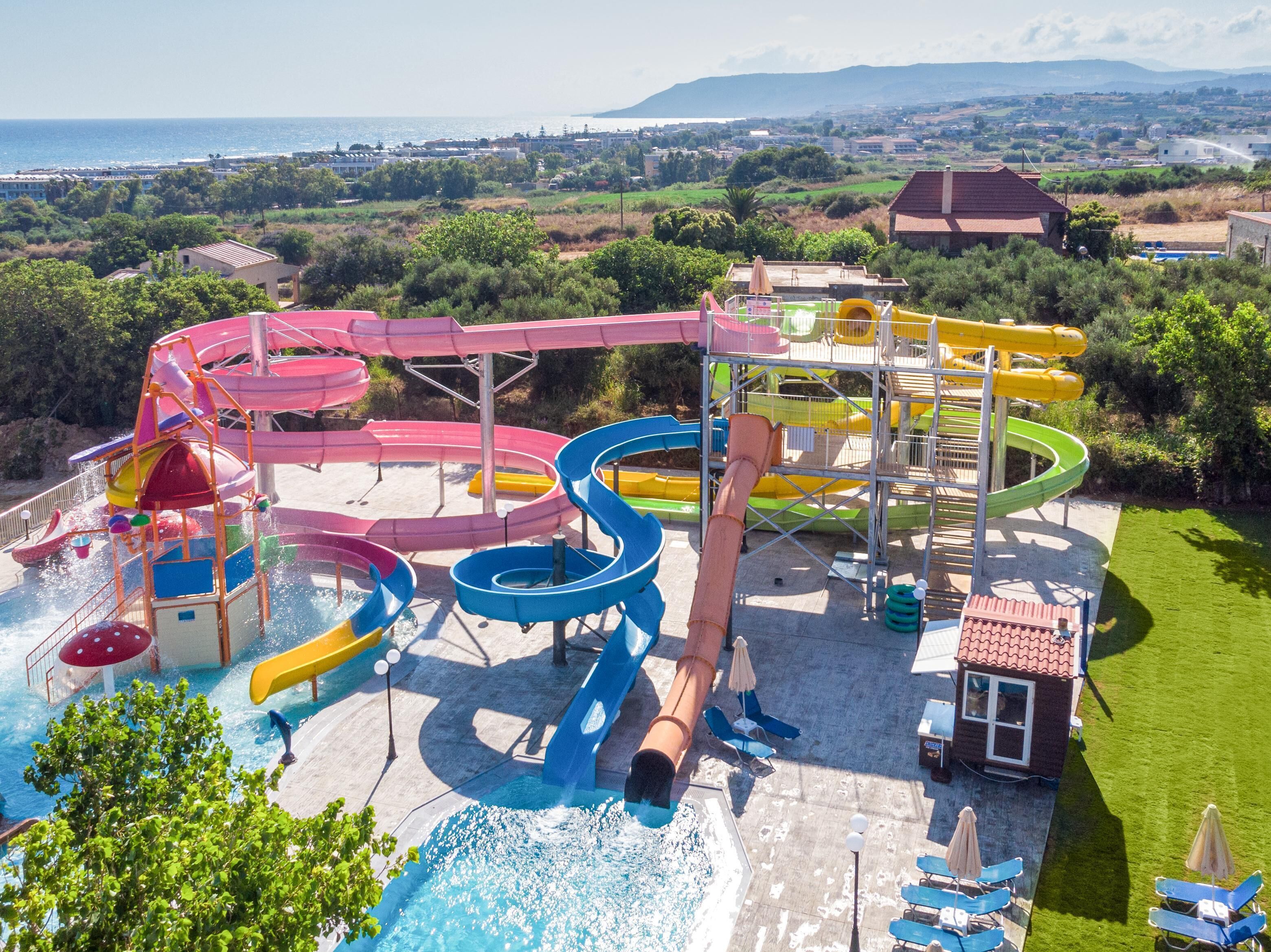 A water park with multiple slides and a pool area.