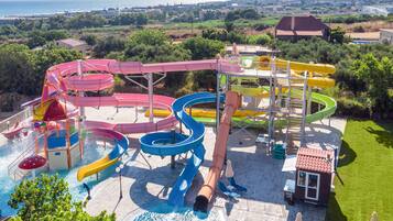 A water park with multiple slides and a pool area.