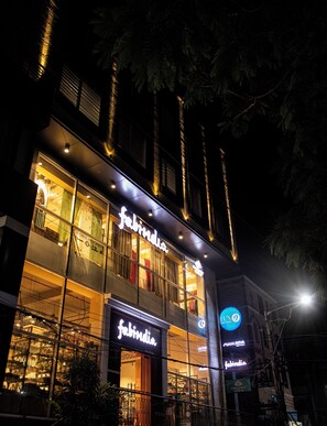 A building with a storefront named 'Fabindia' at night.