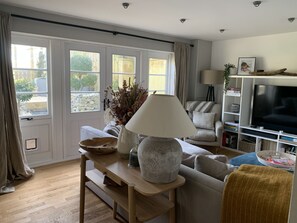 Relax in a bright and airy living room with a comfortable sofa and a large window.